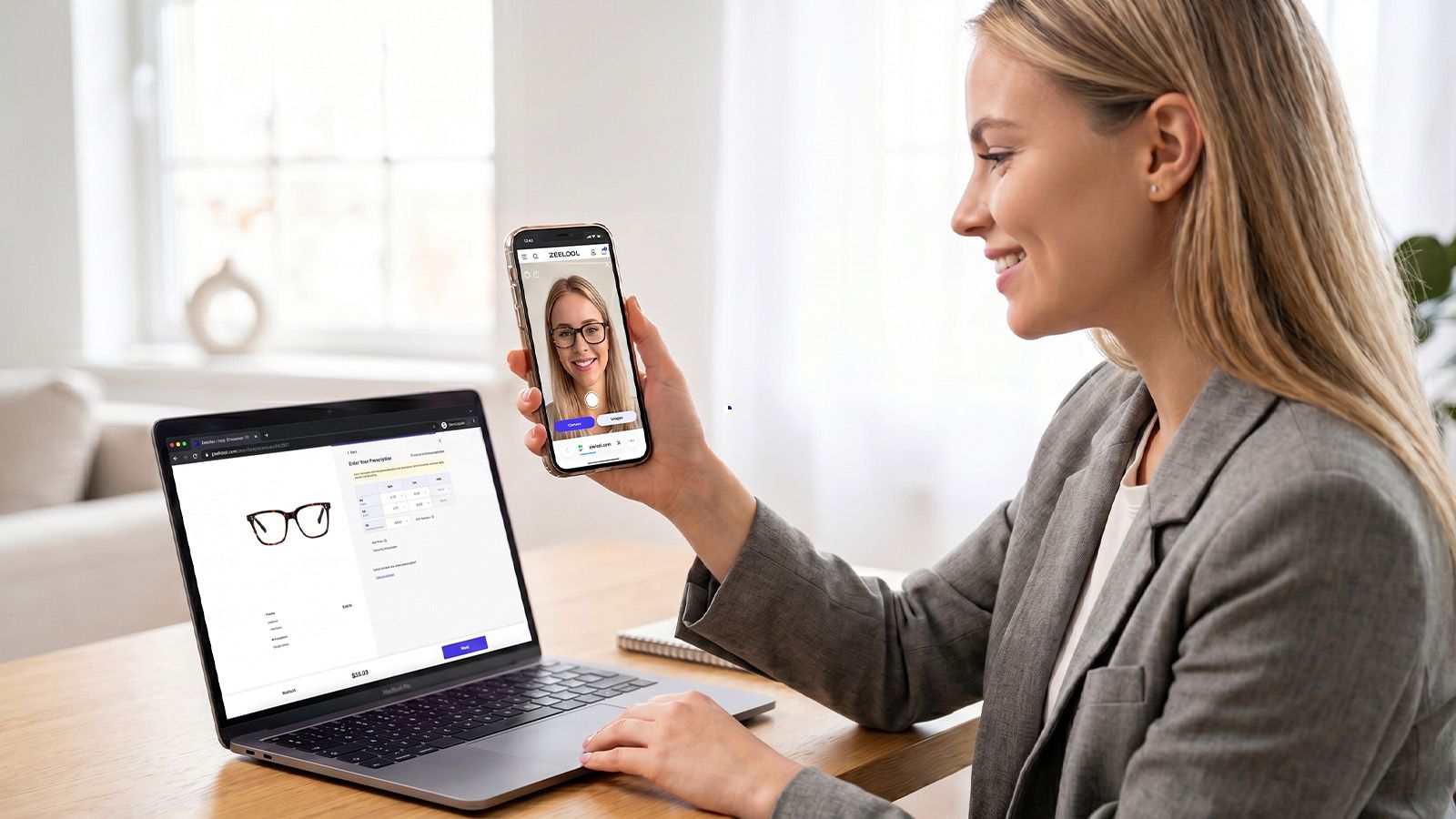 Woman using SatisVision AR virtual try-on app on phone while entering prescription data on laptop.