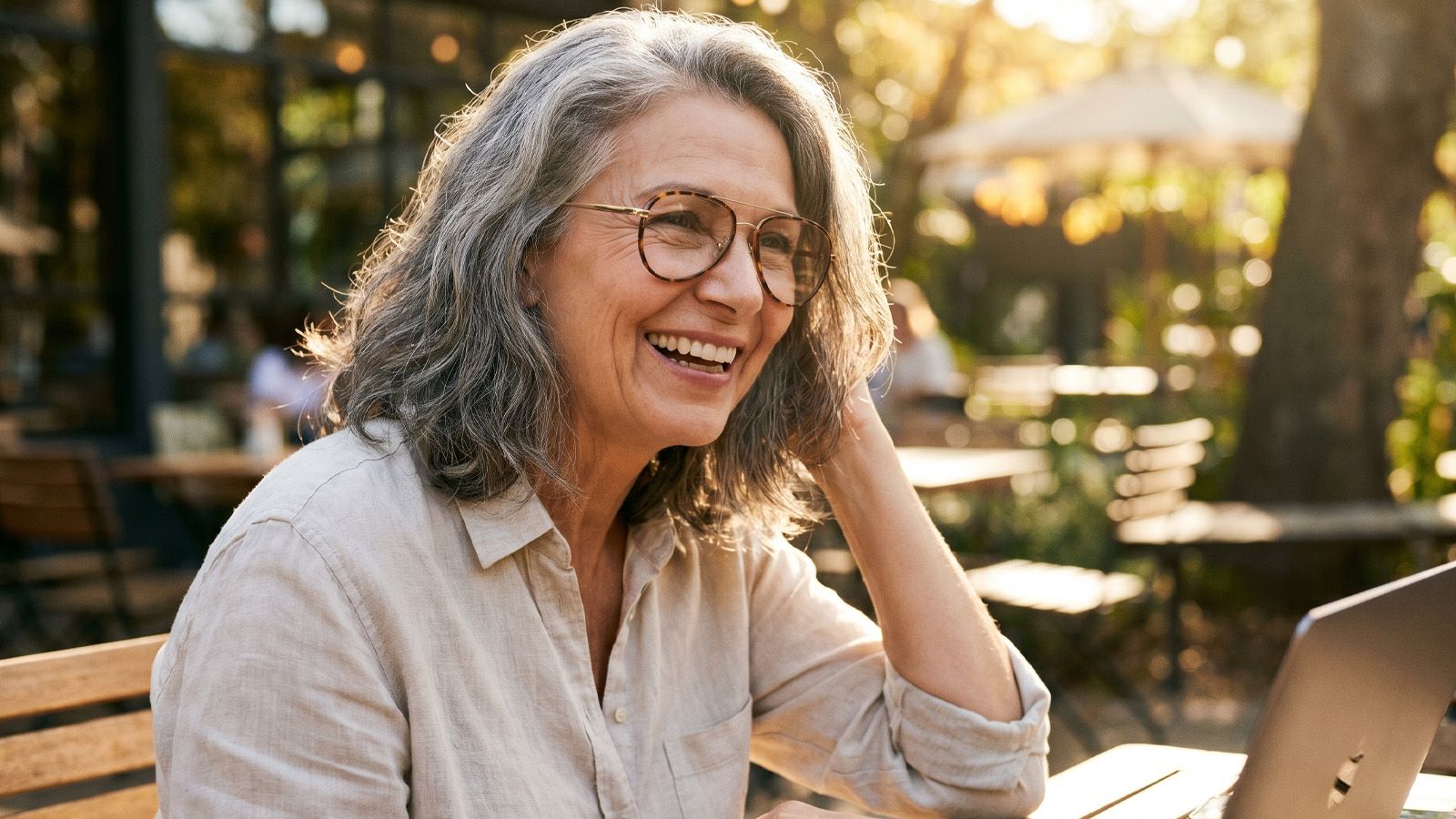 Mature adult woman wearing lightweight aviator glasses outdoors